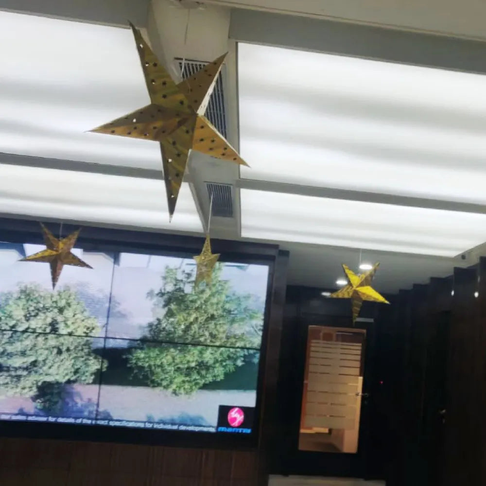 Hire Christmas ceiling decoration for office with hanging festive stars