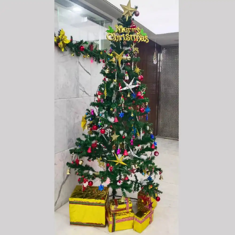 Book decorated Christmas tree for office with gold garlands and ornaments