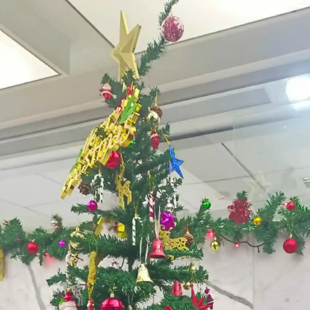 Book Christmas tree decor for office with star ornaments and festive garlands