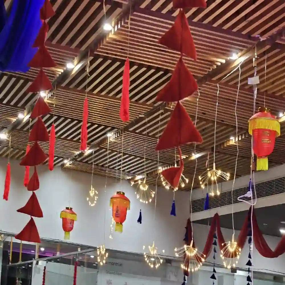 Get Diwali Decor in Office with ceiling lights, colourful wall hangings and traditional festive decorations