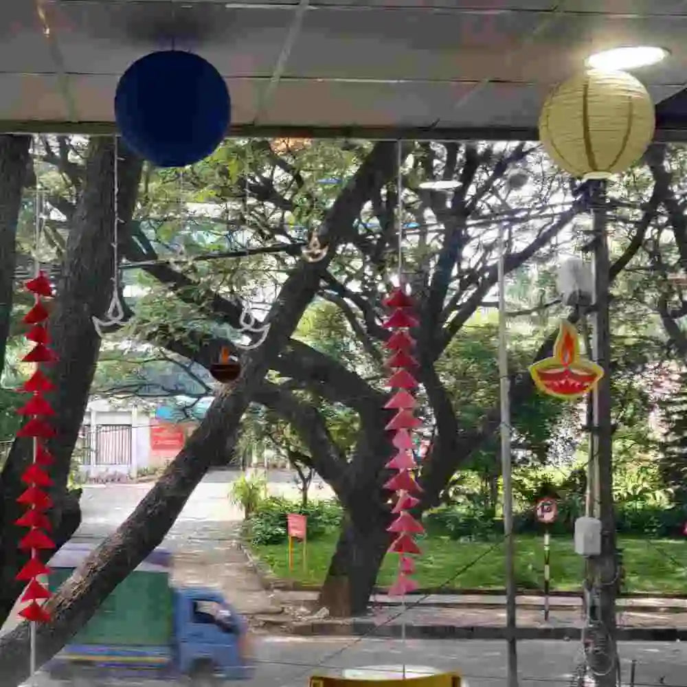 Book Diwali Decor in Office with hanging lanterns, diya decorations and colourful festive streamers