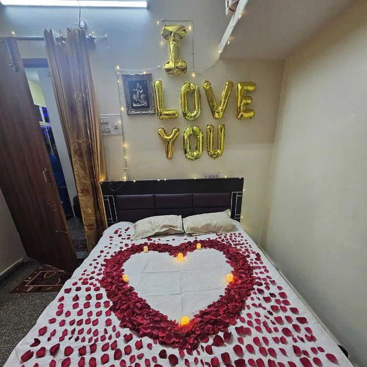 Book first night romantic bed decoration with rose petals and warm candle lights