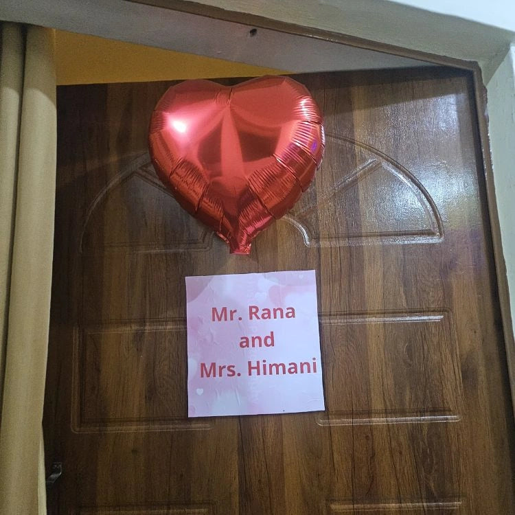 Book first night room decoration with heart balloon and personalized welcome door