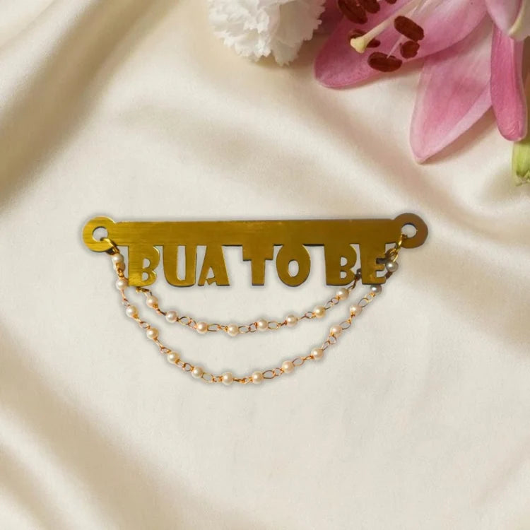 Shop gold Bua to Be baby shower badge with pearl chain