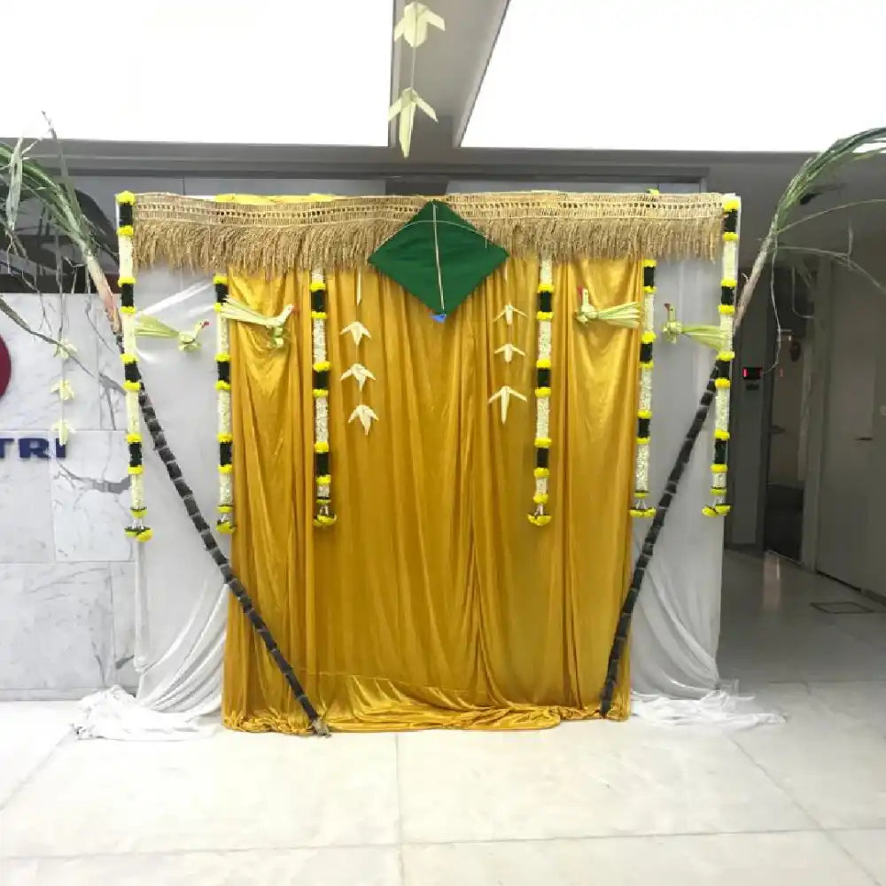 Book Gold Pongal office decoration with traditional fabric backdrop and kites