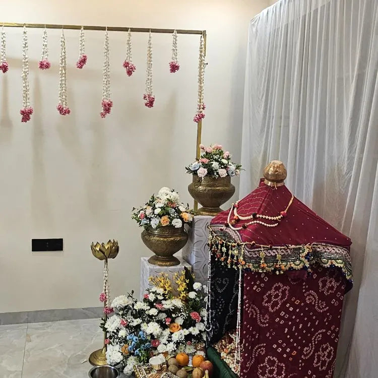Book traditional floral pooja decoration with brass vases and flower arrangements