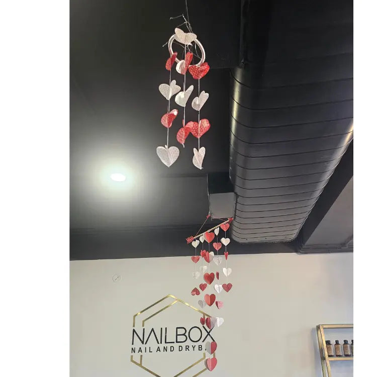 Book Valentine's Day interior decoration with hanging hearts and pompoms