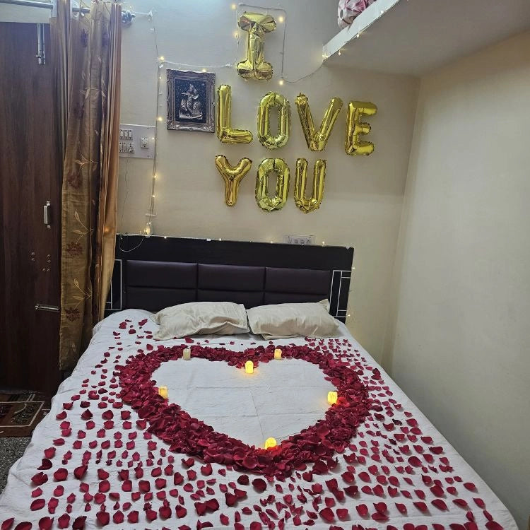 Enquire about wedding night bed decoration with rose petal heart and candles